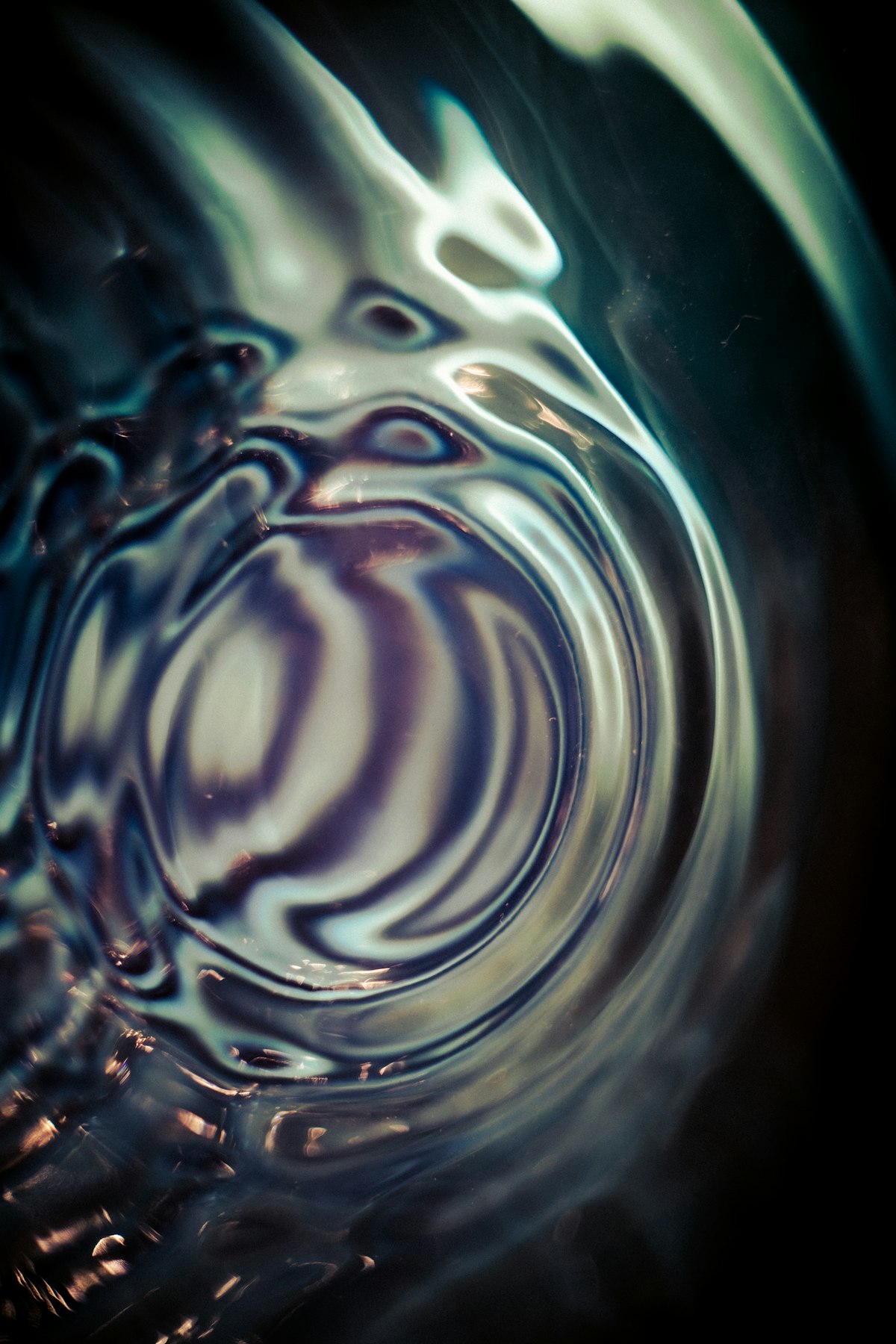 Close-up of swirling, rippling water catching light