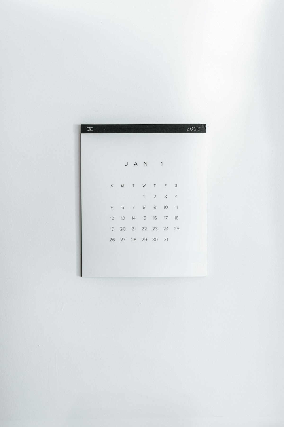 A plain white wall calendar showing the January 2020 grid, every date from 1 to 31 printed and not one of them written on
