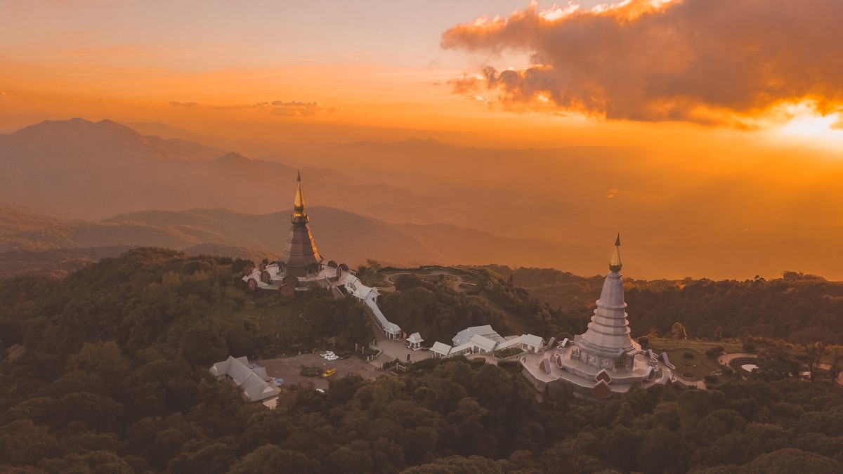 Golden-hour aerial view of the twin pagodas atop Doi Inthanon in Chiang Mai province