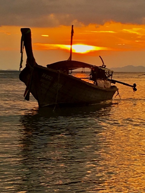 Sunset over a longtail boat off Railay